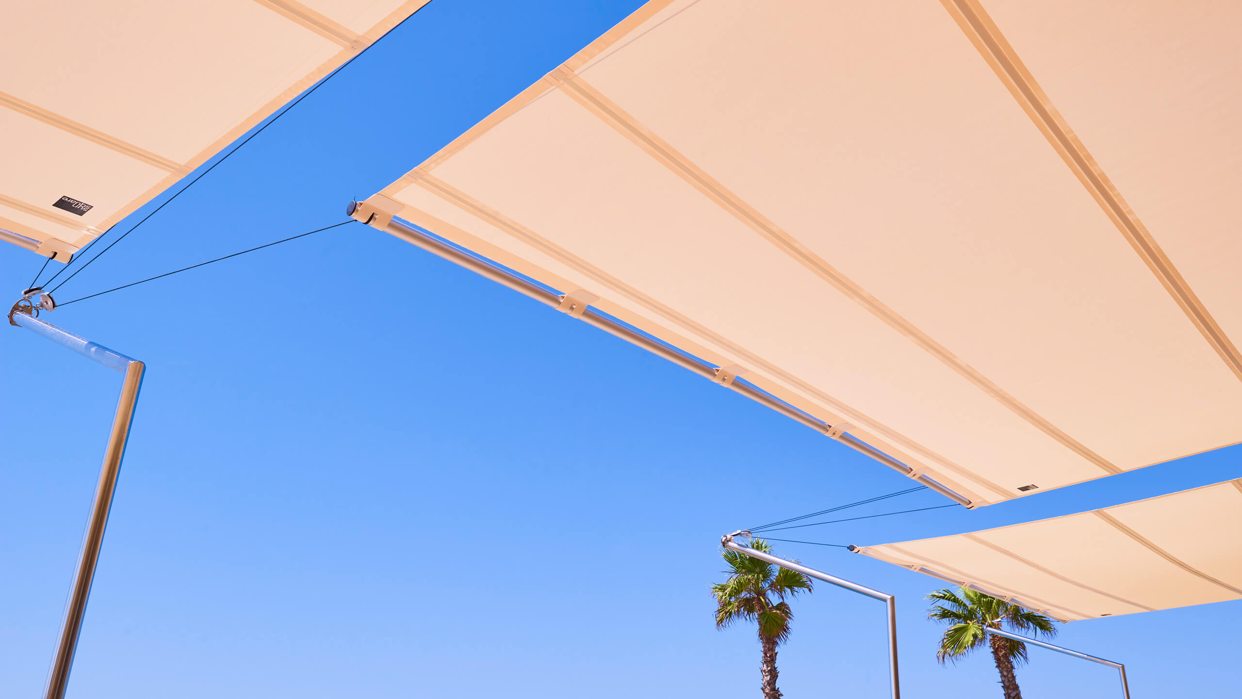 automatic sun sail deployed over minimalist white Ibiza luxury villa terrace