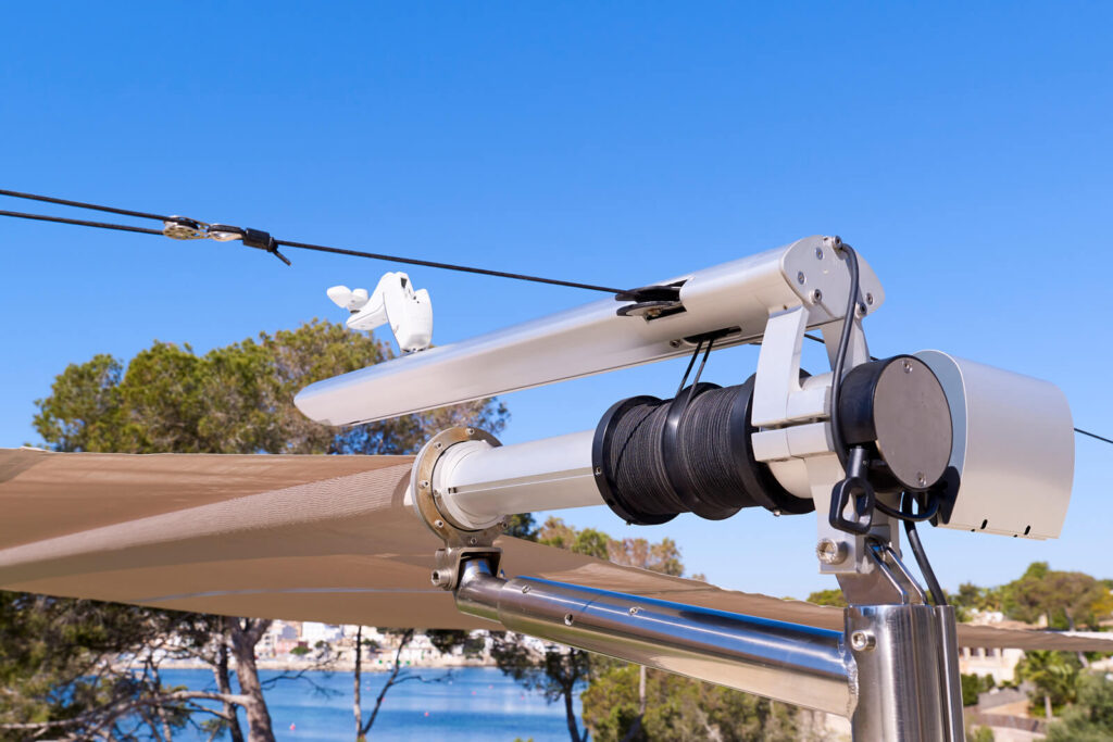 Sun Sail patented system close-up — cup-type anemometer wind sensor, soft-tension cable drive drum, motor housing and marine stainless mast