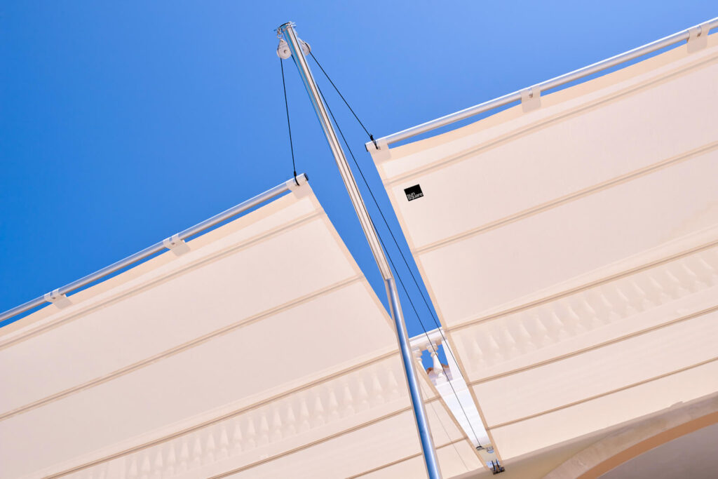 Sun Sail automatic sail providing large-scale coverage at Ibiza luxury villa terrace, modular configuration covering generous outdoor living space with pool