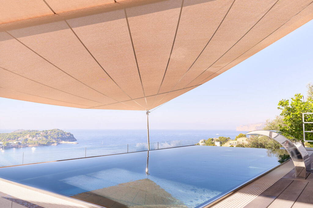 Sun Sail 80 m² at Port d'Andratx harbourfront villa Mallorca — custom wind threshold for elevated harbour exposure, three Balearic winters verified without mechanical issue