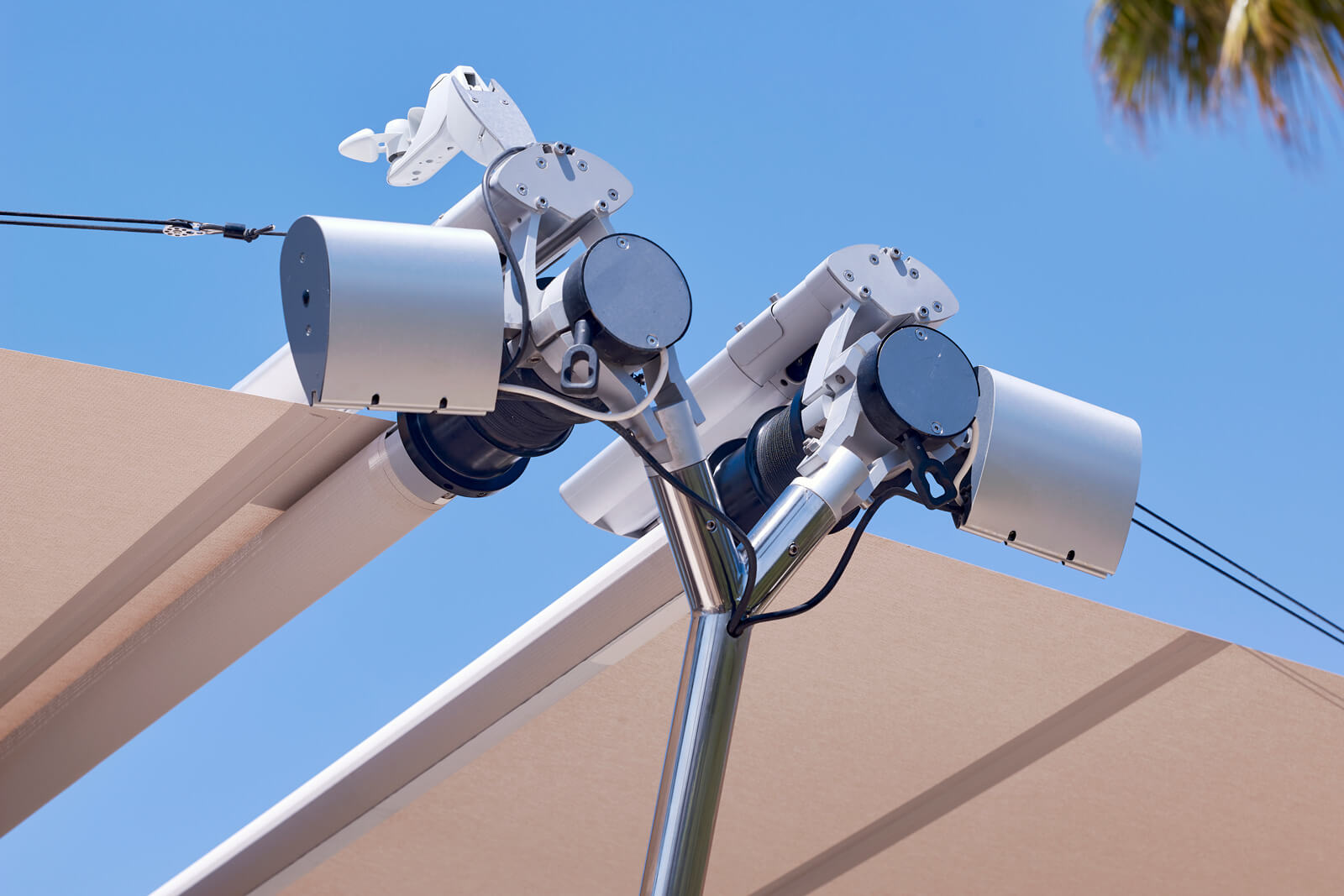 Sun Sail patented soft-tension drive assembly and cup-type anemometer at mast apex — wind sensor triggering automatic retraction Mallorca villa