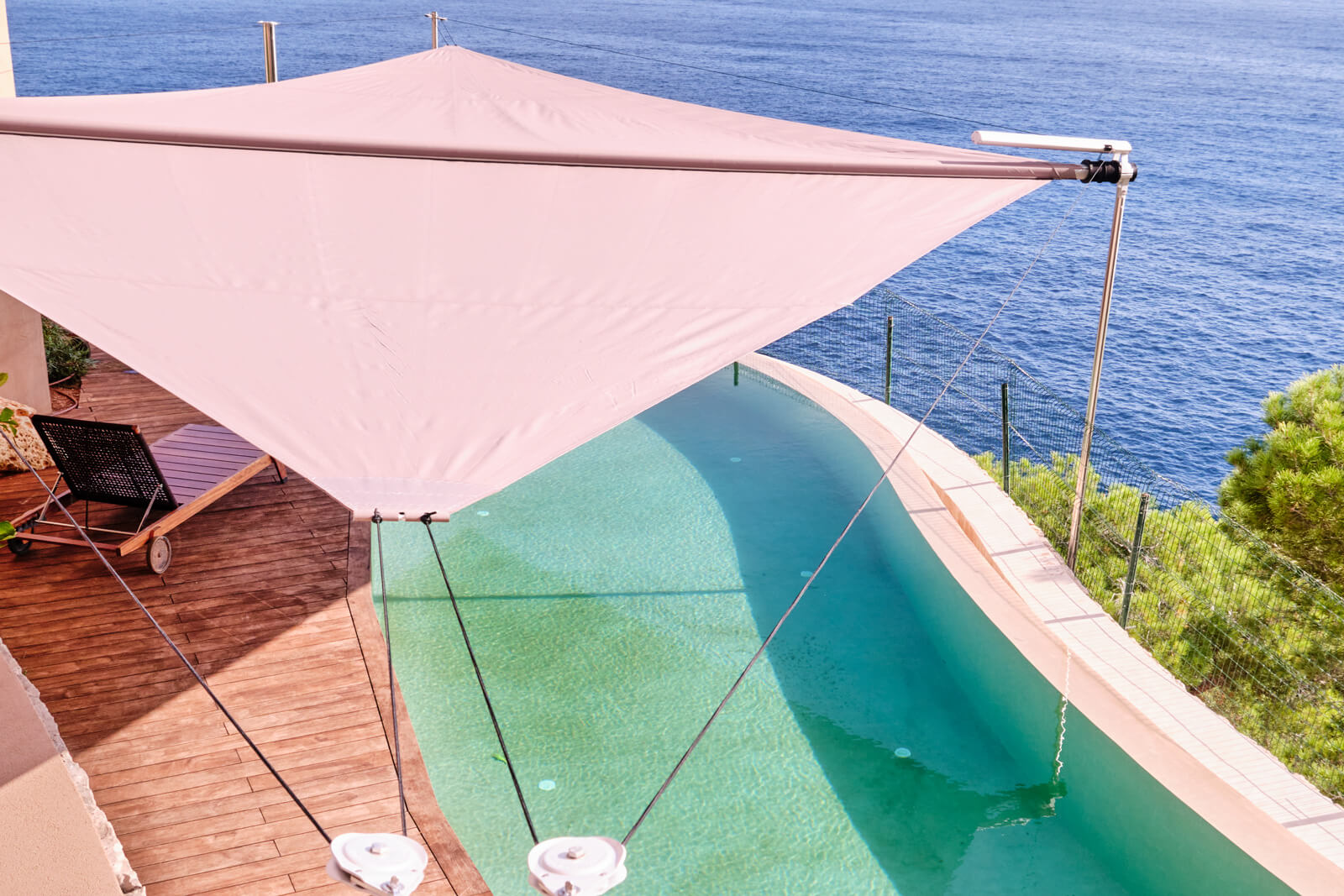 Aerial drone shot of Sun Sail deployed over Son Vida villa Palma Mallorca — 120 m² coordinated coverage, pool terrace, Tramuntana mountain range visible, late-morning light
